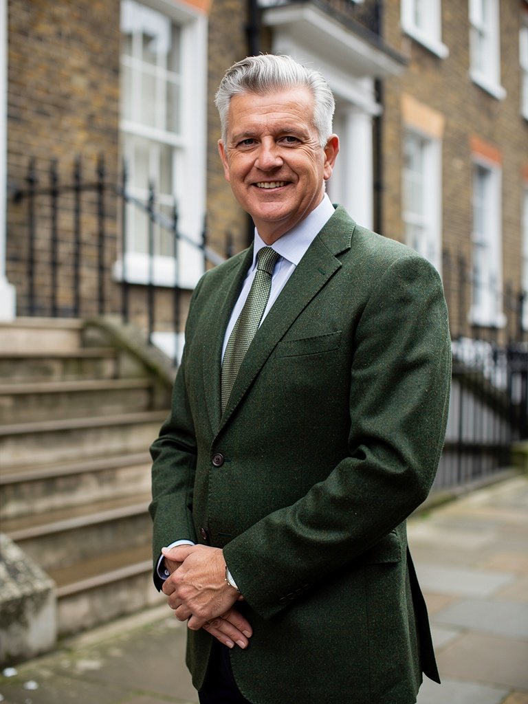 Richard Hartley, founder of Portsmouth Surveyors UK, standing outside a Georgian terrace in Old Portsmouth